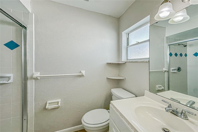 bathroom featuring vanity, toilet, and an enclosed shower