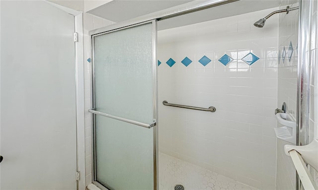 bathroom with a shower with door