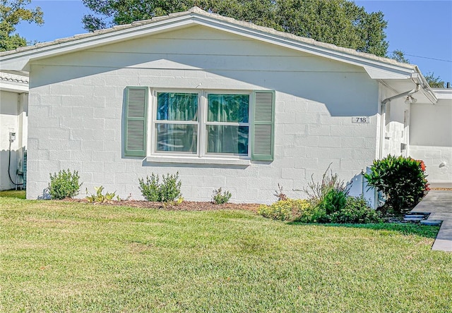 view of side of home featuring a lawn