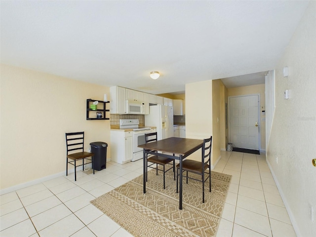 dining space with light tile patterned floors and baseboards