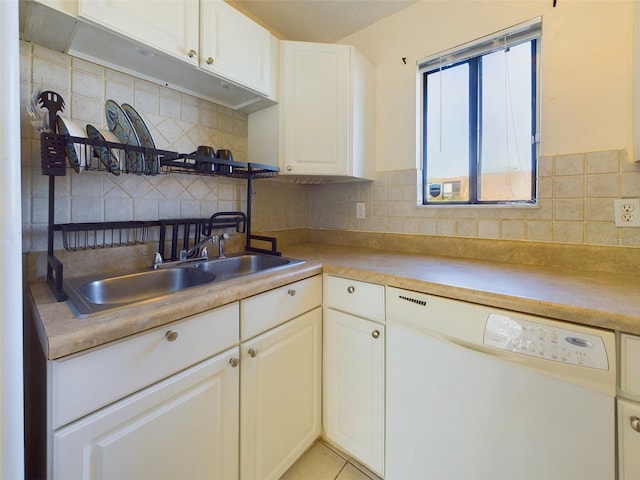 kitchen with decorative backsplash, light countertops, dishwasher, and a sink