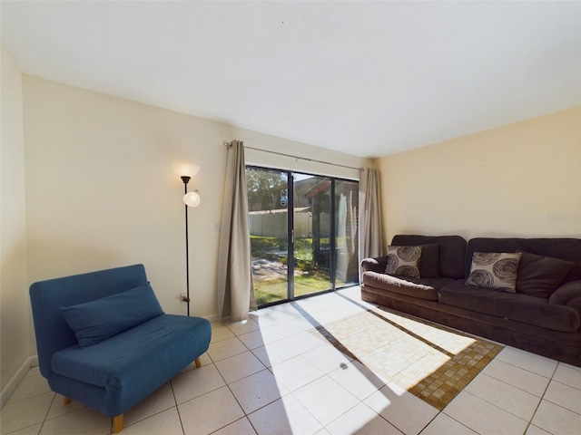 living room with light tile patterned floors and baseboards