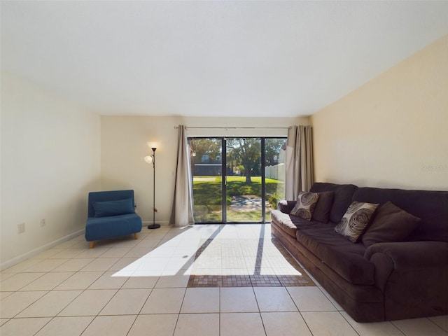 living room with baseboards and light tile patterned floors