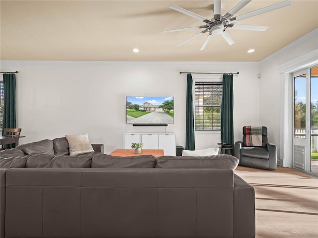 living room featuring carpet, a wealth of natural light, ornamental molding, and ceiling fan