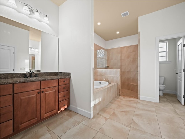 full bathroom with plus walk in shower, vanity, toilet, and tile patterned flooring