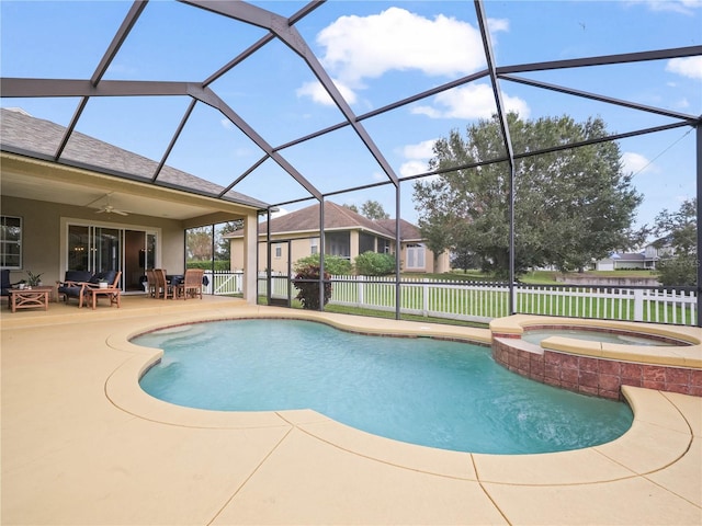 view of pool with a patio area, ceiling fan, glass enclosure, and an in ground hot tub