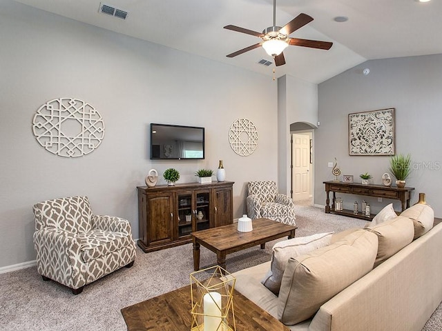 living room with ceiling fan, light colored carpet, and lofted ceiling