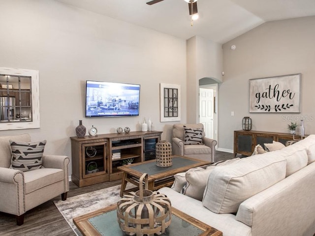 living room with hardwood / wood-style floors, ceiling fan, and lofted ceiling