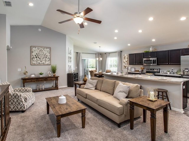 living room with ceiling fan, lofted ceiling, and light carpet