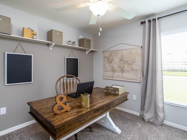 carpeted office space featuring ceiling fan