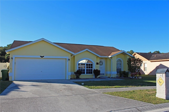 ranch-style home with a front yard and a garage