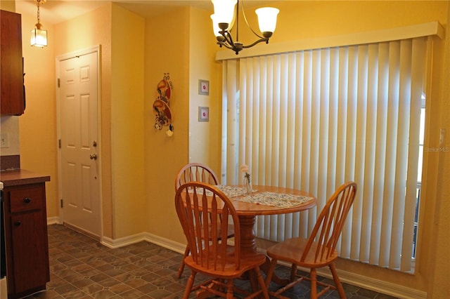 dining space featuring a notable chandelier