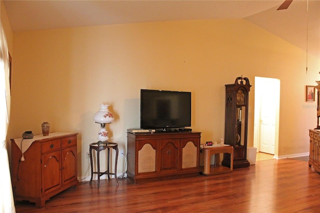 living room featuring hardwood / wood-style flooring, ceiling fan, and lofted ceiling