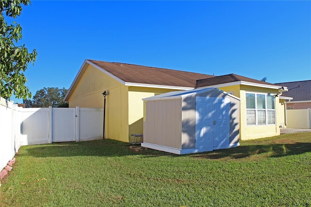 exterior space featuring a yard and a storage unit