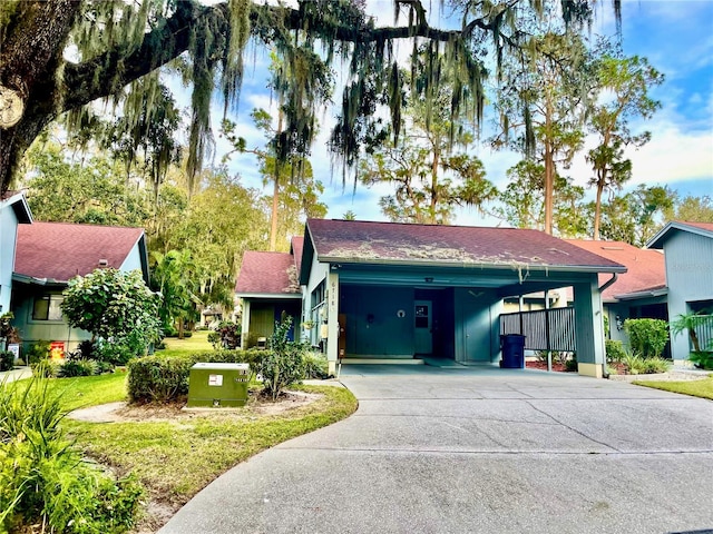 view of front of home with a front yard and a carport