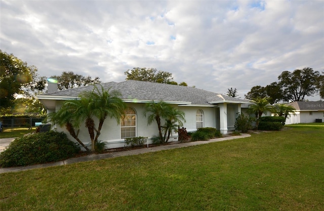 ranch-style home featuring a front yard