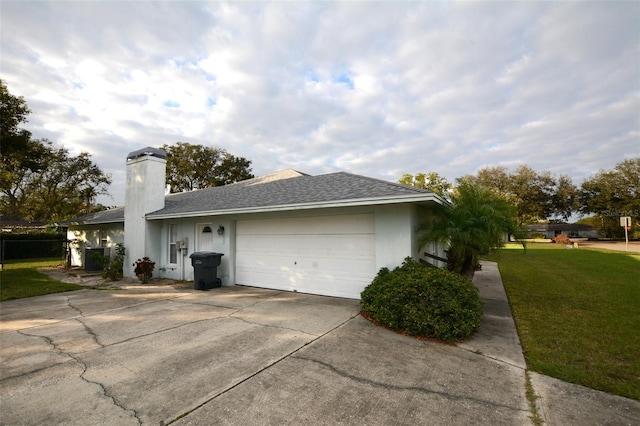 view of side of home featuring a garage and a yard