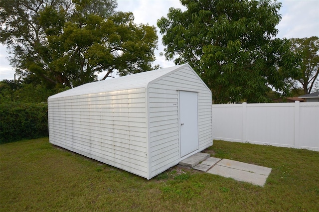 view of outbuilding with a yard