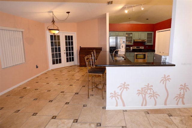 kitchen with french doors, stainless steel appliances, hanging light fixtures, green cabinets, and kitchen peninsula