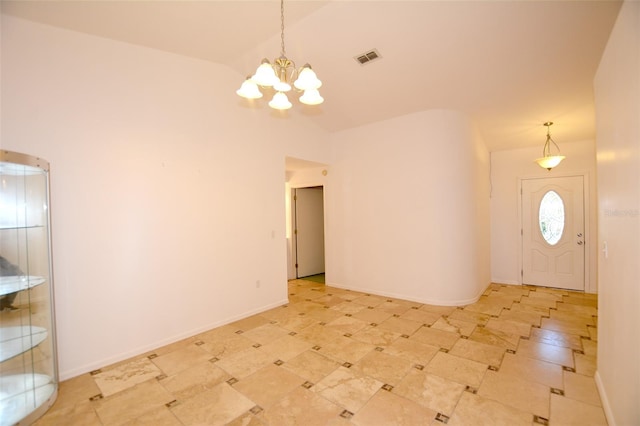 foyer featuring vaulted ceiling and an inviting chandelier