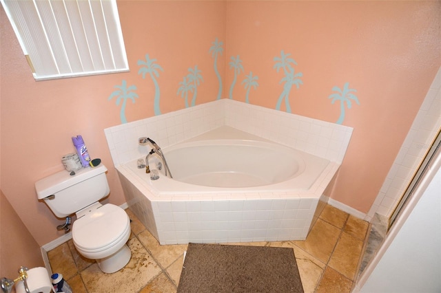 bathroom featuring toilet and tiled tub