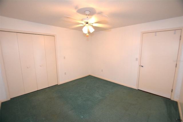 unfurnished bedroom with ceiling fan, a closet, and dark carpet