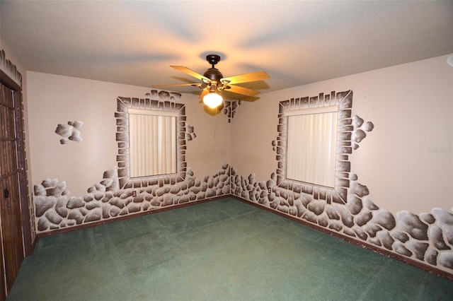 carpeted spare room featuring ceiling fan