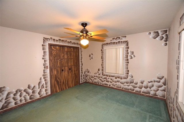 unfurnished bedroom featuring ceiling fan and carpet floors