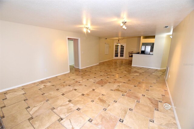 2556 Roslyn Ln, Lakeland, FL 33812 - unfurnished living room with baseboards, a textured ceiling, and visible vents