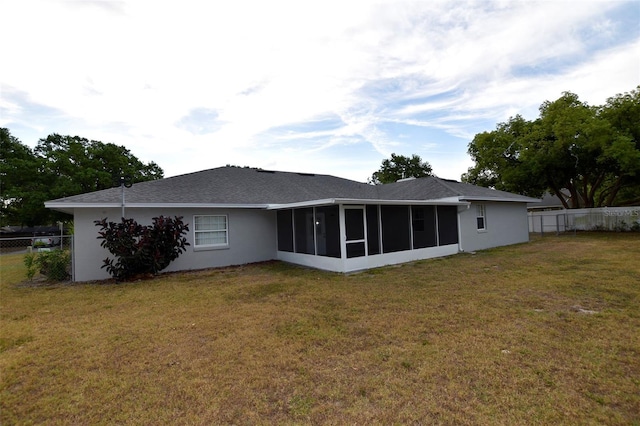 2556 Roslyn Ln, Lakeland, FL 33812 - back of property featuring a fenced backyard, a sunroom, and a lawn