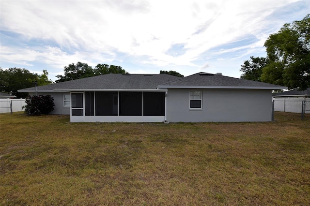 2556 Roslyn Ln, Lakeland, FL 33812 - rear view of house with stucco siding, a yard, a sunroom, and fence