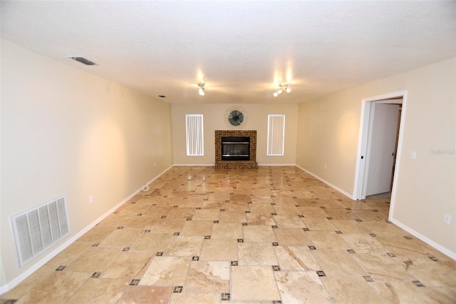 2556 Roslyn Ln, Lakeland, FL 33812 - unfurnished living room featuring baseboards, a glass covered fireplace, and visible vents