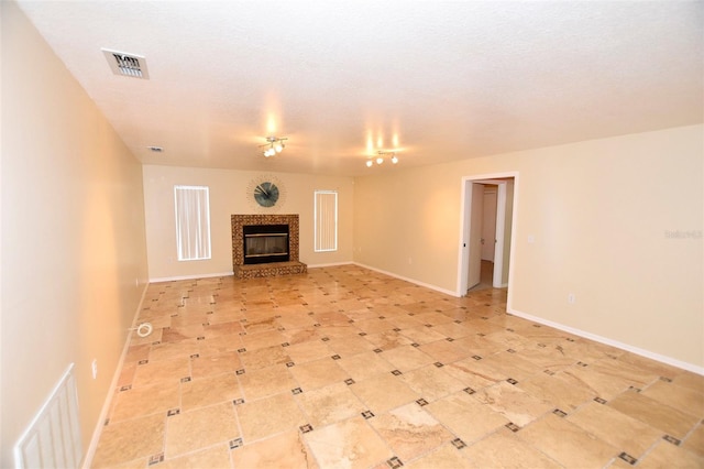2556 Roslyn Ln, Lakeland, FL 33812 - unfurnished living room featuring baseboards, a tile fireplace, and visible vents