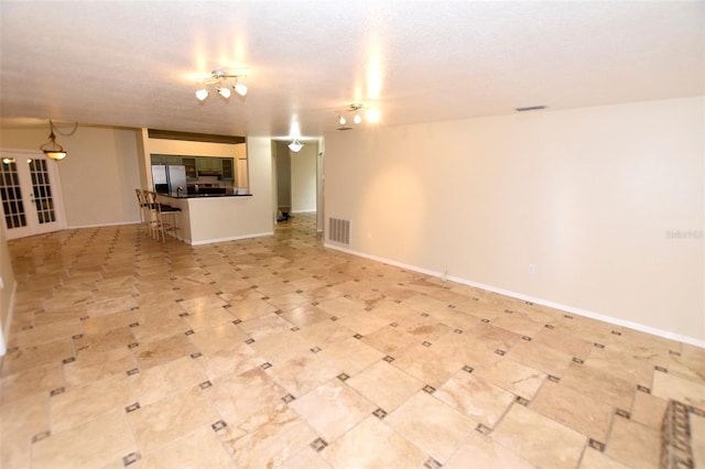2556 Roslyn Ln, Lakeland, FL 33812 - unfurnished living room featuring light floors, baseboards, and visible vents