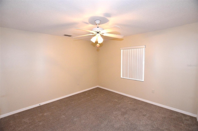 2556 Roslyn Ln, Lakeland, FL 33812 - spare room featuring a textured ceiling, ceiling fan, baseboards, dark colored carpet, and visible vents