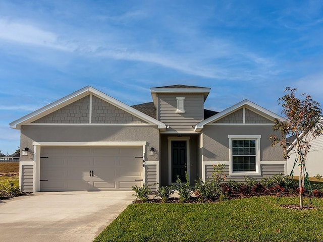 craftsman-style house featuring a garage and a front yard