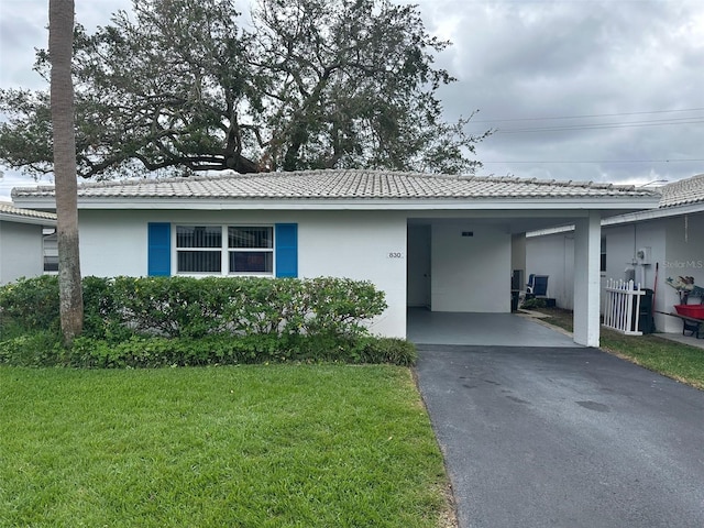 ranch-style home with a front lawn and a carport