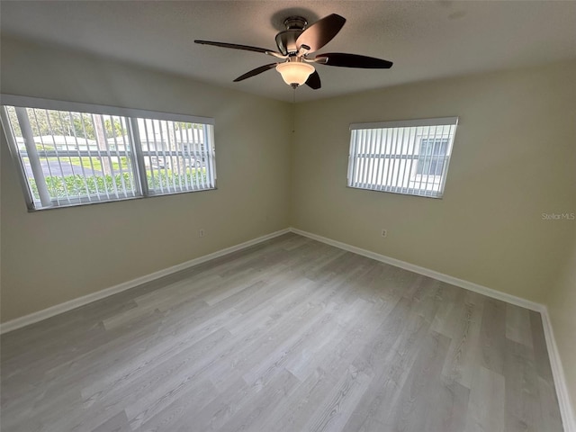 unfurnished room with ceiling fan and light wood-type flooring