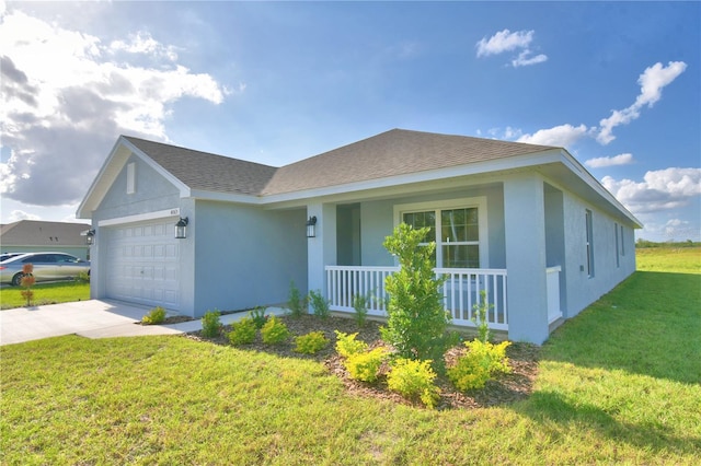 ranch-style house with covered porch, a front yard, and a garage