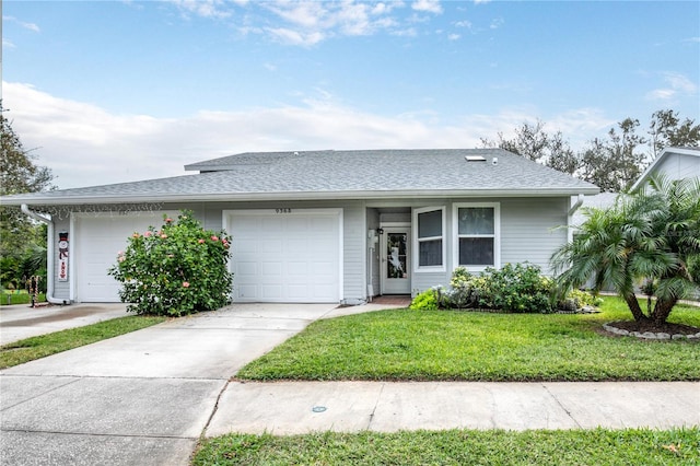 single story home with a front yard and a garage