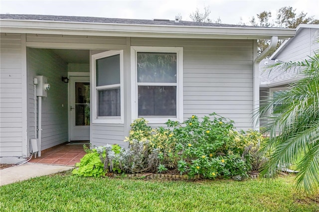 doorway to property featuring a yard