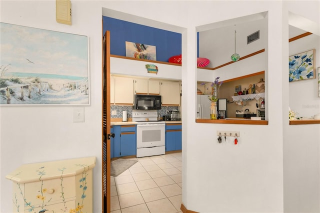 kitchen featuring decorative backsplash, white appliances, and light tile patterned flooring