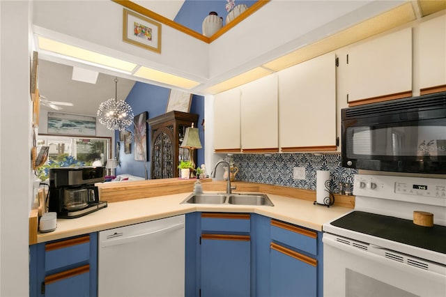 kitchen featuring sink, a chandelier, decorative light fixtures, white appliances, and white cabinets