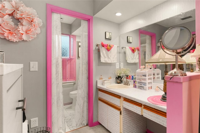 bathroom featuring vanity and toilet