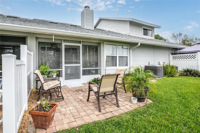 exterior space with central AC unit, a patio area, and a yard