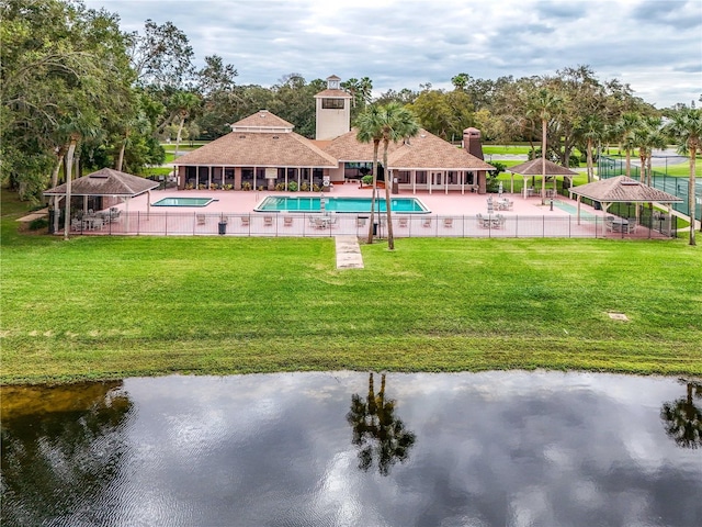 view of swimming pool featuring a gazebo, a yard, a water view, and a patio