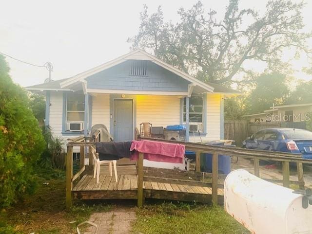 rear view of house featuring a wooden deck