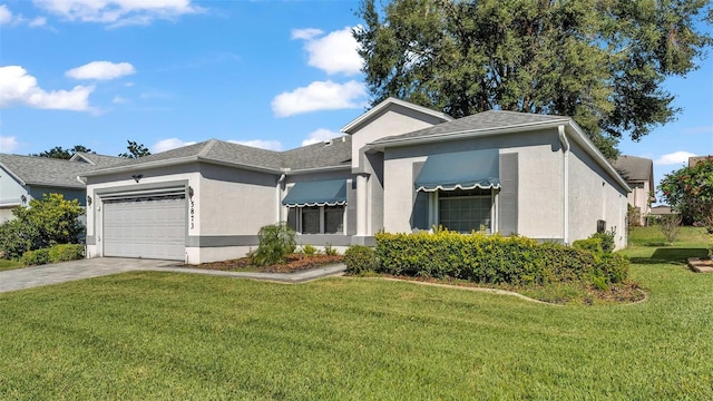 view of front of property with a front lawn and a garage