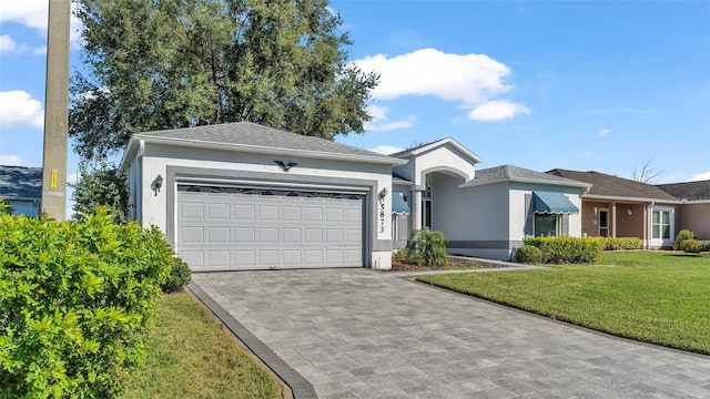 single story home featuring a front yard and a garage