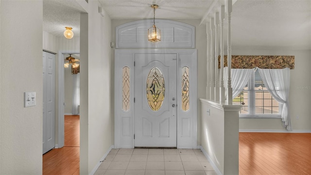 entryway featuring a textured ceiling and light wood-type flooring